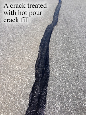 A crack treated with hot pour crack fill